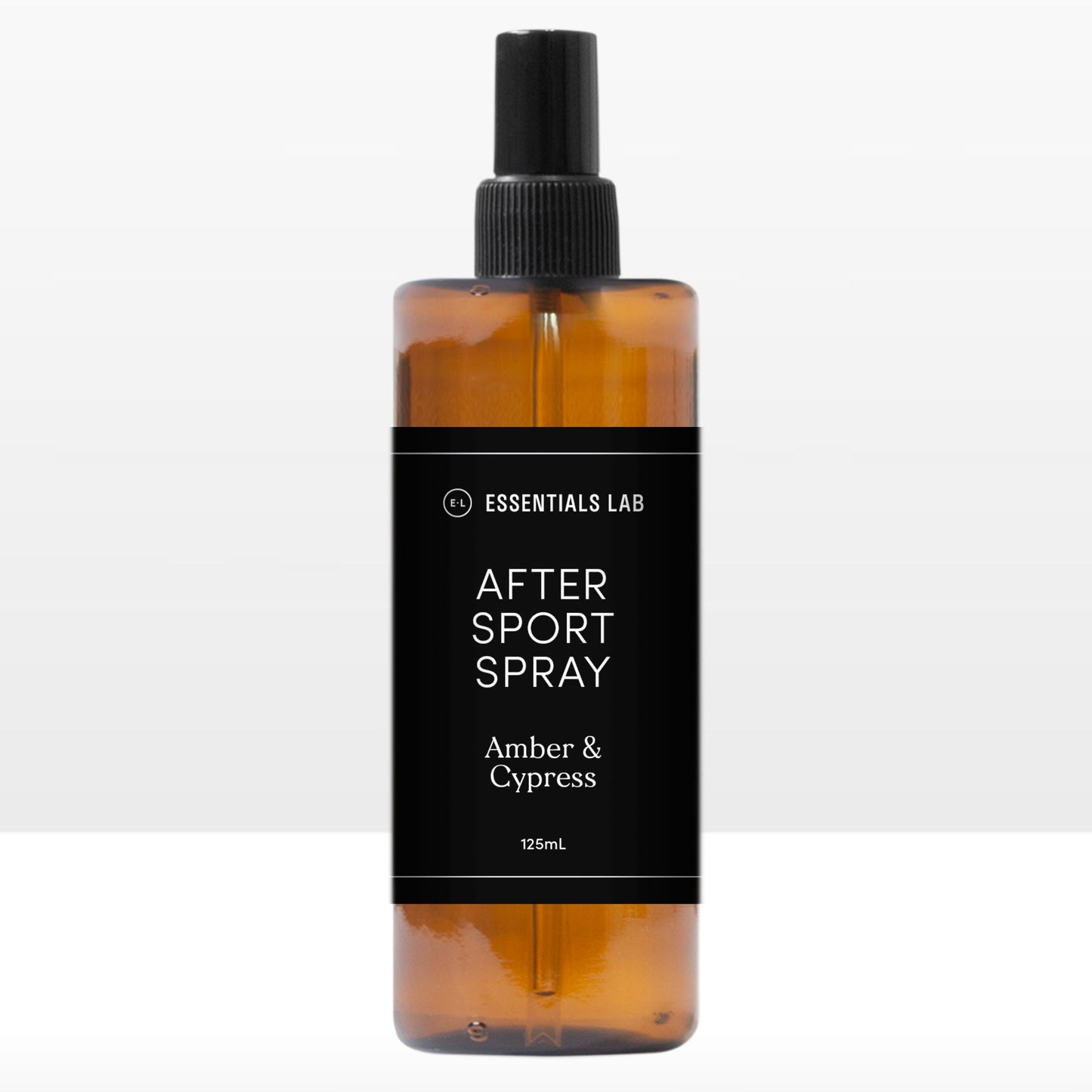 A clear amber spray bottle labeled 'AFTER SPORT SPRAY Amber & Cypress' on a white background.